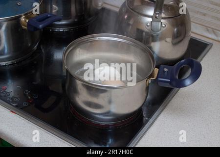 cooking in modern electric stove to cook eggs for Easter holiday Stock Photo