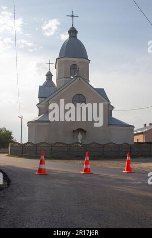 the new road is closed by road cones on the background of the church Stock Photo