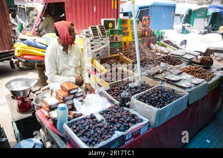 Man sat at his street market stall in Varanasi India Stock Photo