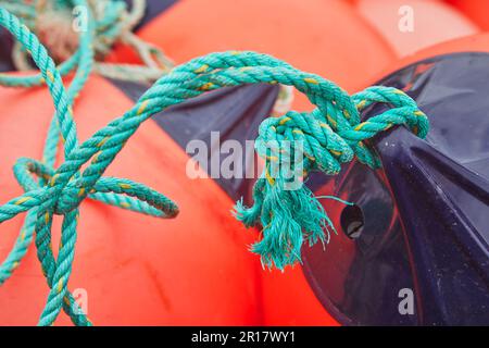 Fishing marker buoys and ropes on shore, beside the harbour at Teignmnouth, Devon, Great Britain. Stock Photo