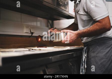 pizza chef prepares dough in wood fired kitchen in germany Stock Photo