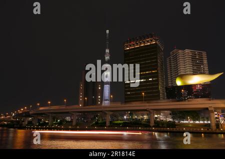 Night view of Tokyo Sky Tree, metropolitan expressway and pleasure boats on Sumida river Stock Photo