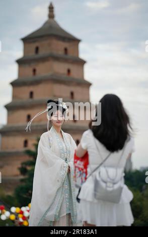 Xi'an, China's Shaanxi Province. 8th May, 2023. Tourists take photos near the Giant Wild Goose Pagoda in Xi'an, northwest China's Shaanxi Province, May 8, 2023. Relying on rich historical and cultural resources, Xi 'an, a city with over 3,100 years of history, by integrating the culture and tourism, promotes and boosts new consumption model to inject new vitality into urban life. Credit: Shao Rui/Xinhua/Alamy Live News
