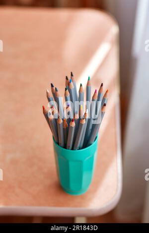 many sharpened colored pencils in a tube side view Stock Photo