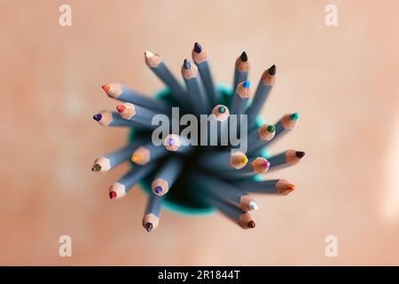 many sharpened colored pencils in a tube top view Stock Photo