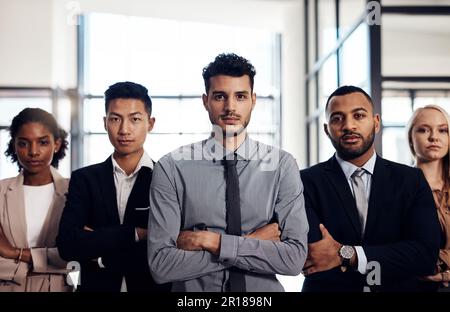 Strong managers lead from the front. a group of confident and diverse young businesspeople working together in a modern office. Stock Photo