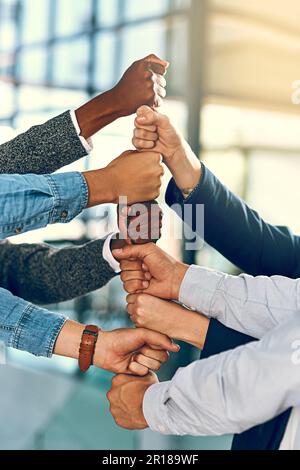 Building a solid support structure. a group of unrecognizable businesspeople stacking fists. Stock Photo