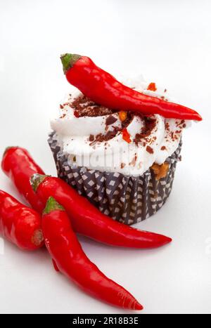 chili cupcake on white with whole chili Stock Photo