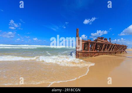Picture of a rusted shipwreck at Seventy Five Mile Beach on Frazer Island in Australia during daytime Stock Photo