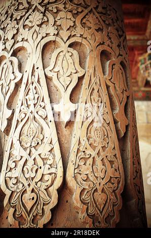 Fragment of old carving wooden column in the ancient mosque in Khiva, Uzbekistan. Close-up Stock Photo