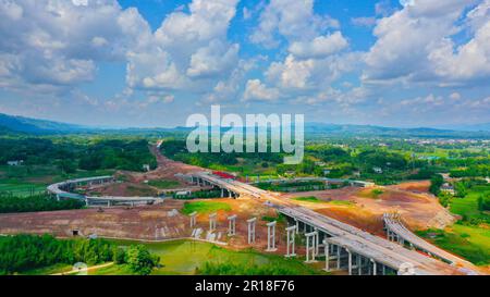 CHONGQING, CHINA - MAY 11, 2023 - Workers work at the construction site of the Qihe Junction of the Liangping to Kaijiang Expressway in Qihe village, Stock Photo