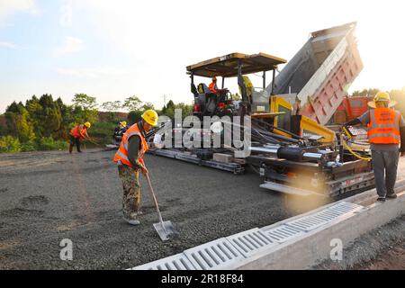 CHONGQING, CHINA - MAY 11, 2023 - Workers work at the construction site of the Qihe Junction of the Liangping to Kaijiang Expressway in Qihe village, Stock Photo