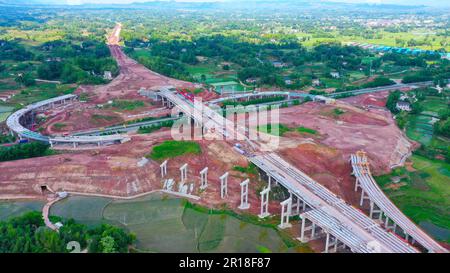 CHONGQING, CHINA - MAY 11, 2023 - Workers work at the construction site of the Qihe Junction of the Liangping to Kaijiang Expressway in Qihe village, Stock Photo