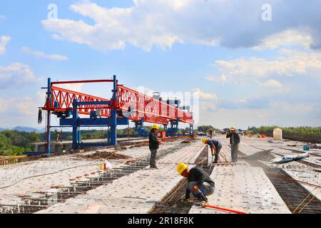 CHONGQING, CHINA - MAY 11, 2023 - Workers work at the construction site of the Qihe Junction of the Liangping to Kaijiang Expressway in Qihe village, Stock Photo