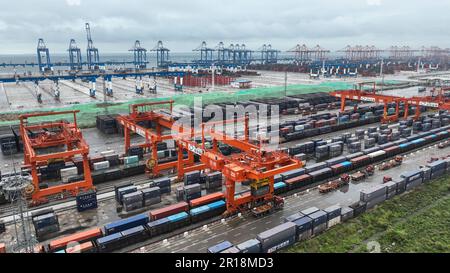 (230512) -- QINZHOU, May 12, 2023 (Xinhua) -- This aerial photo taken on May 11, 2023 shows an automatic container terminal of Qinzhou Port and a railway container distribution center in Qinzhou City, south China's Guangxi Zhuang Autonomous Region. With boosts from the Regional Comprehensive Economic Partnership (RCEP) and the Belt and Road Initiative (BRI), the New International Land-Sea Trade Corridor saw over 300,000 twenty-foot equivalent units (TEUs), an increase of 14 percent year-on-year, being transported by the rail-sea intermodal freight trains this year. At present, over 940 kinds o Stock Photo