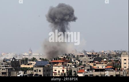 Smoke rises above buildings in Rafah, in the southern Gaza Strip, following an Israeli strike on Friday May 12, 2023. Israel and Gaza militants traded heavy fire. Photo by Ismael Mohamad/UPI Credit: UPI/Alamy Live News Stock Photo