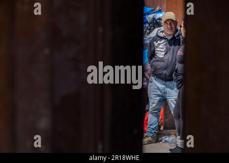 San Diego, USA. 11th May, 2023. An asylum-seeker waits for the end of Title 42 in an encampment between the border fences west of the San Ysidro Port of Entry on May 11, 2023. (Matthew Bowler/KPBS/Sipa USA) **NO SALES IN SAN DIEGO-SAN DIEGO OUT** Credit: Sipa USA/Alamy Live News Stock Photo