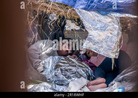 San Diego, USA. 11th May, 2023. A family of migrants is seen through the border fence west of the San Ysidro Port of Entry on May 11, 2023. (Matthew Bowler/KPBS/Sipa USA) **NO SALES IN SAN DIEGO-SAN DIEGO OUT** Credit: Sipa USA/Alamy Live News Stock Photo