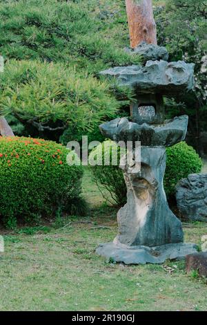 Japanese style stone lantern in Shinjuku Gyoen National Garden Stock Photo