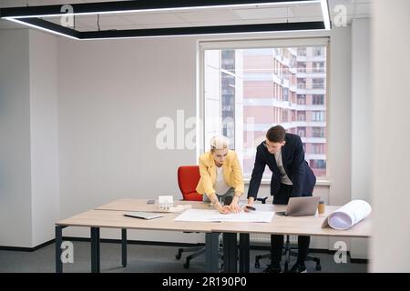 Architects drawing building plan in the office Stock Photo