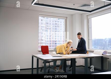 Developers representatives reviewing building plan in the office Stock Photo