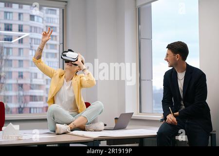 Excited woman looking at house design through virtual reality glasses Stock Photo