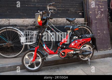 Chinese Aibo electric / electrical powered bike / bike / cycle / bicycle parked on the street in Pingyao Ancient City, Shanxi province, China. PRC. (125) Stock Photo