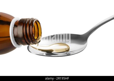 Pouring syrup into spoon from bottle isolated on white, closeup. Cough and cold medicine Stock Photo