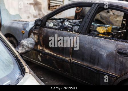A cropped front view of a burned and abandoned rusty cars Stock Photo ...