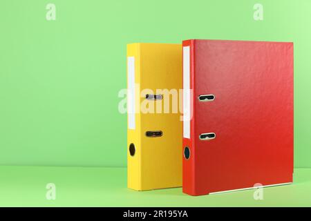 Office folders on light green background, space for text Stock Photo
