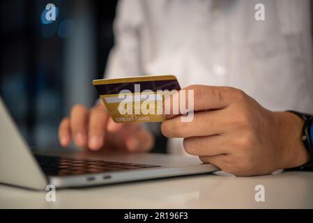 man hands holding credit card using internet payment laptop computer, online shopping digital banking, Business financial technology concept. Stock Photo