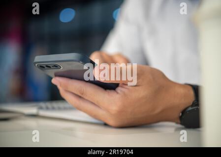 man using mobile smart phone and working.education and technology concept, student working, Freelance. Stock Photo