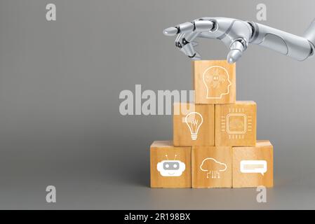hand touch robot artificial intelligence wood cube with AI symbols Futuristic technology Stock Photo