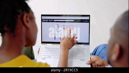 African American Couple Shopping Online On Laptop Stock Photo