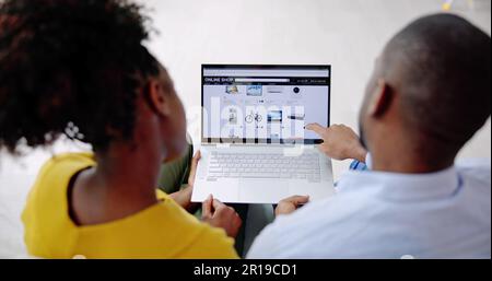 Close-up Of A Couple Using Laptop For Shopping Online Stock Photo