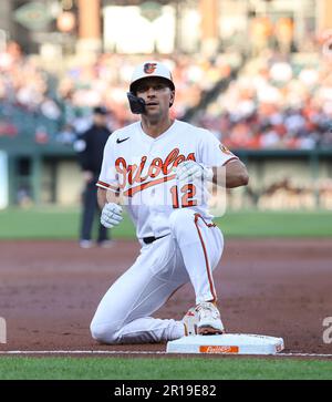 Baltimore Orioles' second baseman Adam Frazier (12) hits a ground ball into  a force play at second but makes it safely to first, driving in a run in  the bottom of the