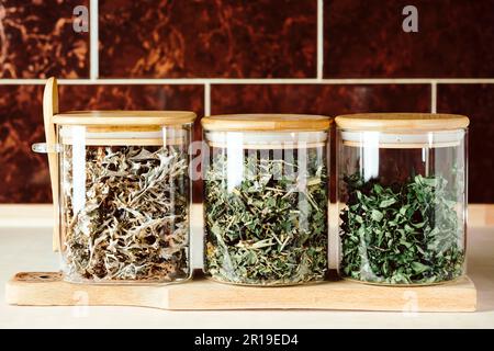 Dry medicinal herbal tea for cough, various ingredients in jars. Stock Photo