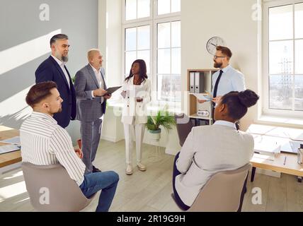 Group of business people in smart casual wear having brainstorm meeting Stock Photo