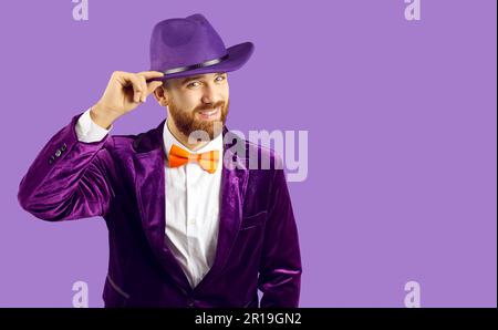 Smiling man performer isolated on purple background Stock Photo