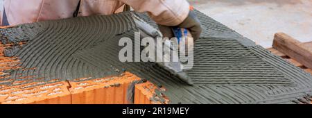 bricklayer working at new built home Stock Photo
