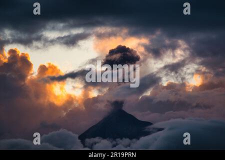 Epic volcanic eruption during the sunset on the background of epic clouds Stock Photo