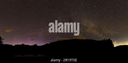 A Panoramic View of the milky way over Blea Tarn in the English Lake District. Stock Photo