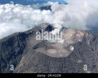 Aerial view of an active volcano with billowing clouds in the ...