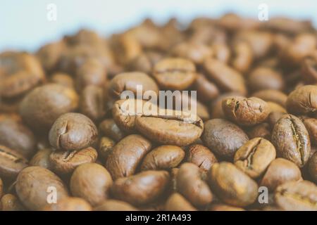 Beautiful texture of freshly roasted selected delicious rich brown natural fragrant coffee tree grains, Arabica coffee beans, Robusta. Copy space on b Stock Photo
