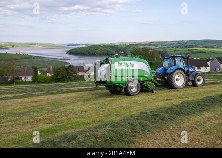 Timoleague, West Cork, Ireland. 12th May, 2023. Barry Long of Eoin Coomey Agri & Plant LTD, bales grass for Timoleague-based farmer John Michael Foley using a New Holland T7.245 tractor and McHale Fusion 3 Plus baler. Credit: AG News/Alamy Live News Stock Photo