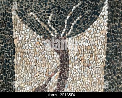 Texture of multicolored stones of different shapes white black hand-made small stems in the form of a beautiful tree, decoration element, interior dec Stock Photo