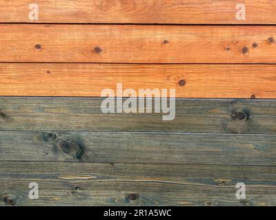 Beautiful wooden texture of horizontal multi-colored boards with knots on a yellow and green wall surface. The background. Texture. Stock Photo