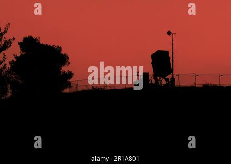 A silhouette of an Iron Dome battery, deployed in the Judea mountains, near jerusalem, Israel, at dusk. Stock Photo