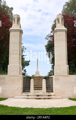 Main entrance to the Military Commonwealth War Graves for WO I and WOII soldiers with crossat the monument at the Cemetery in Etaples, France Stock Photo