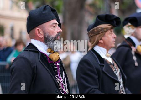 Sardinian men dressed in folk traditional costumes, with unique elements representing the area they come from, join the Saint Efisio Feast festival Stock Photo